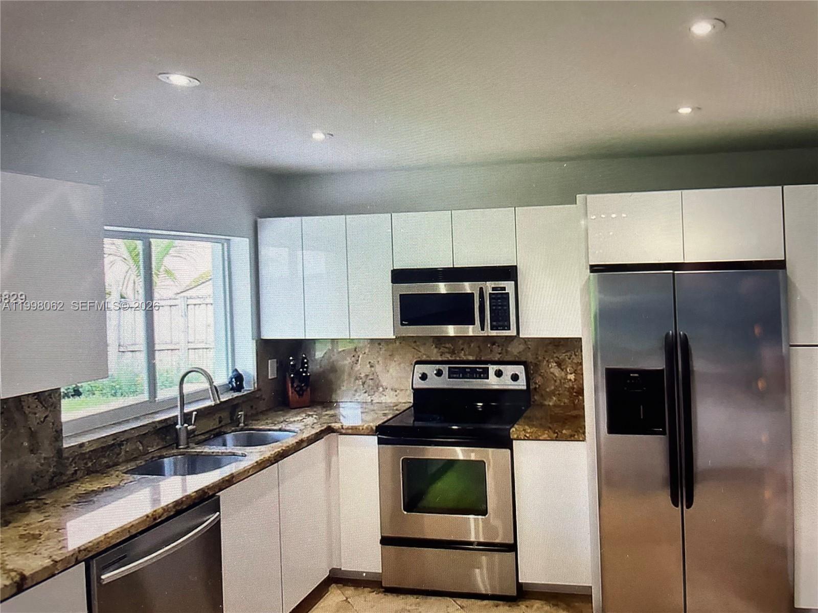 10900 Southwest 107th Avenue Miami, FL 33176 - Photo 5 of 26 a kitchen with stainless steel appliances a refrigerator sink and microwave