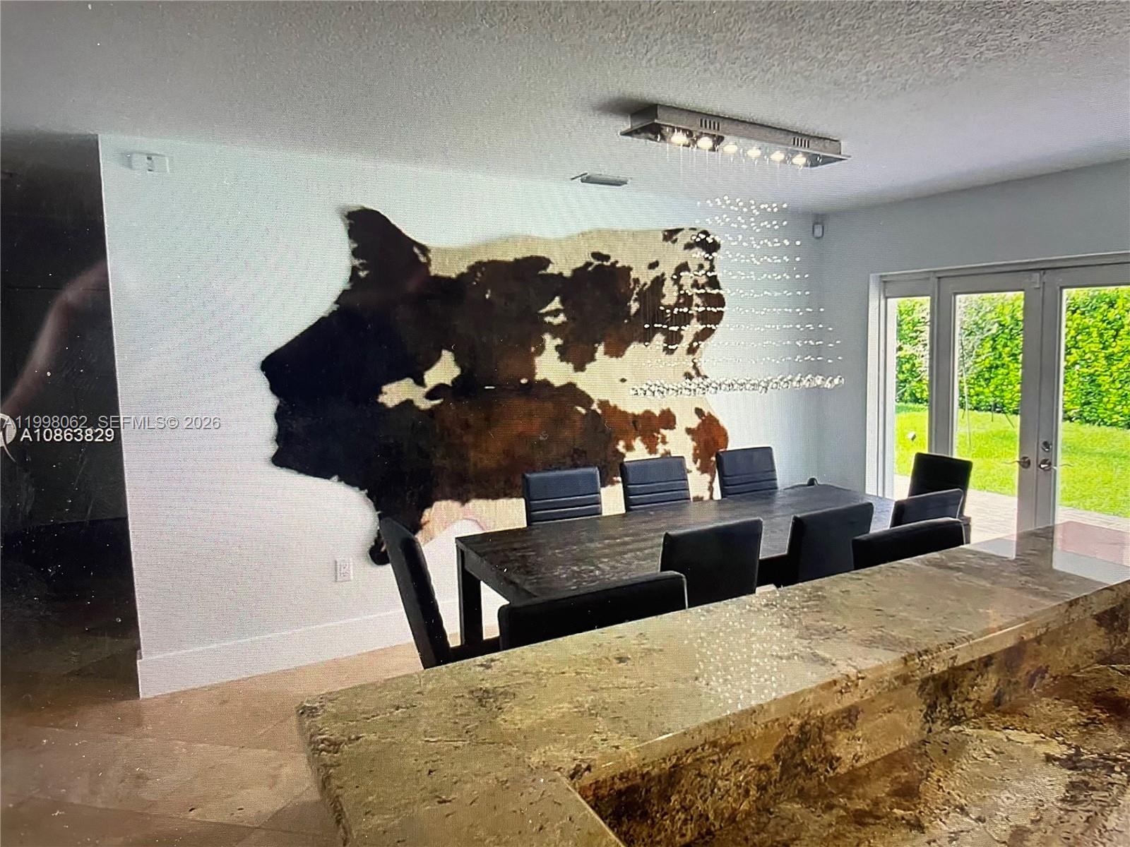 10900 Southwest 107th Avenue Miami, FL 33176 - Photo 8 of 26 a living room with a large bed and large windows