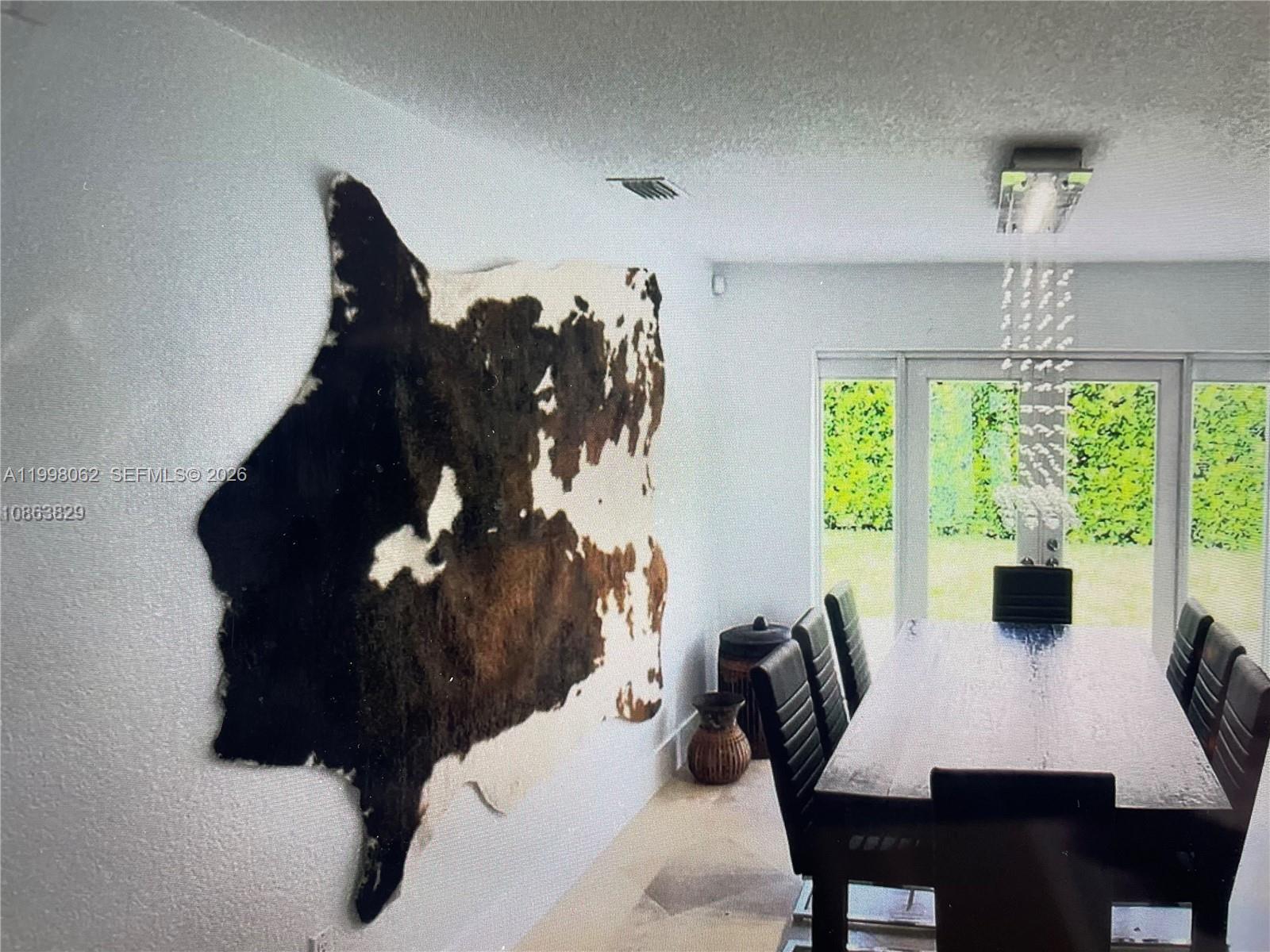 10900 Southwest 107th Avenue Miami, FL 33176 - Photo 9 of 26 a view of a dining room with furniture and chandelier