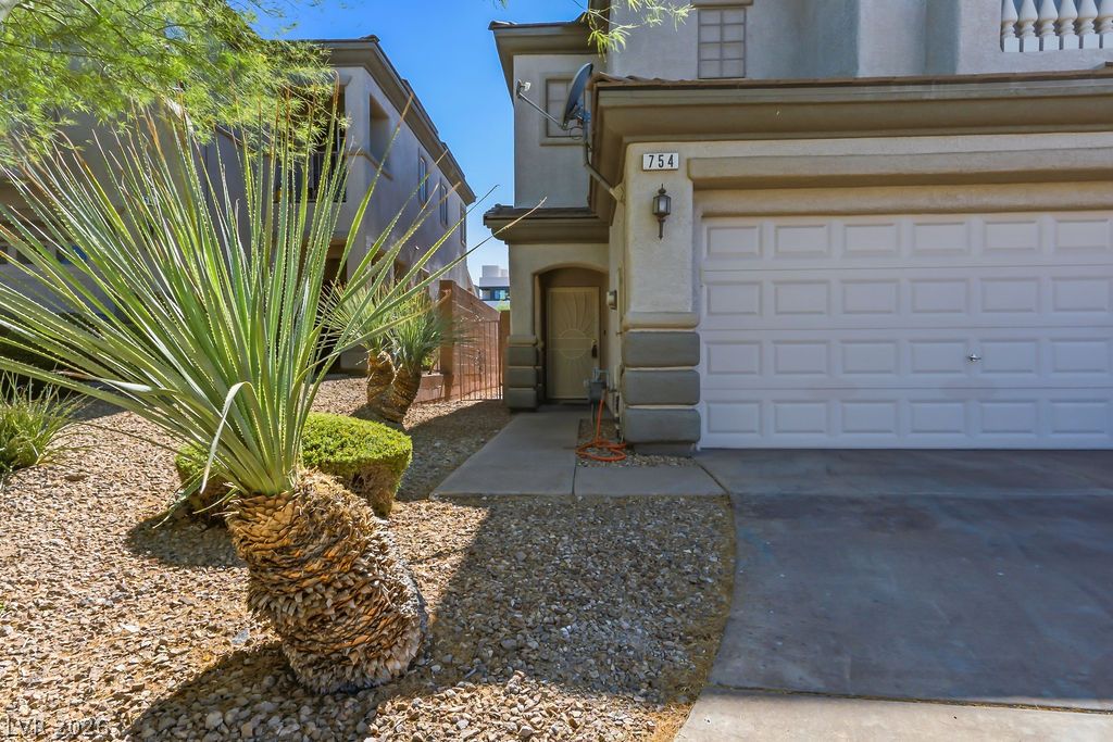 754 Solitude Point Avenue Henderson, NV 89012 - Photo 8 of 38 A welcoming front exterior features an integrated garage and low-maintenance desert landscaping.