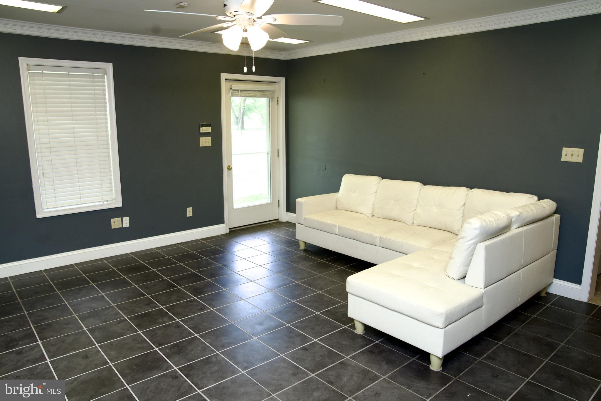 31867 Shavox Road Salisbury, MD 21804 - Photo 43 of 64 a living room with furniture and a chandelier