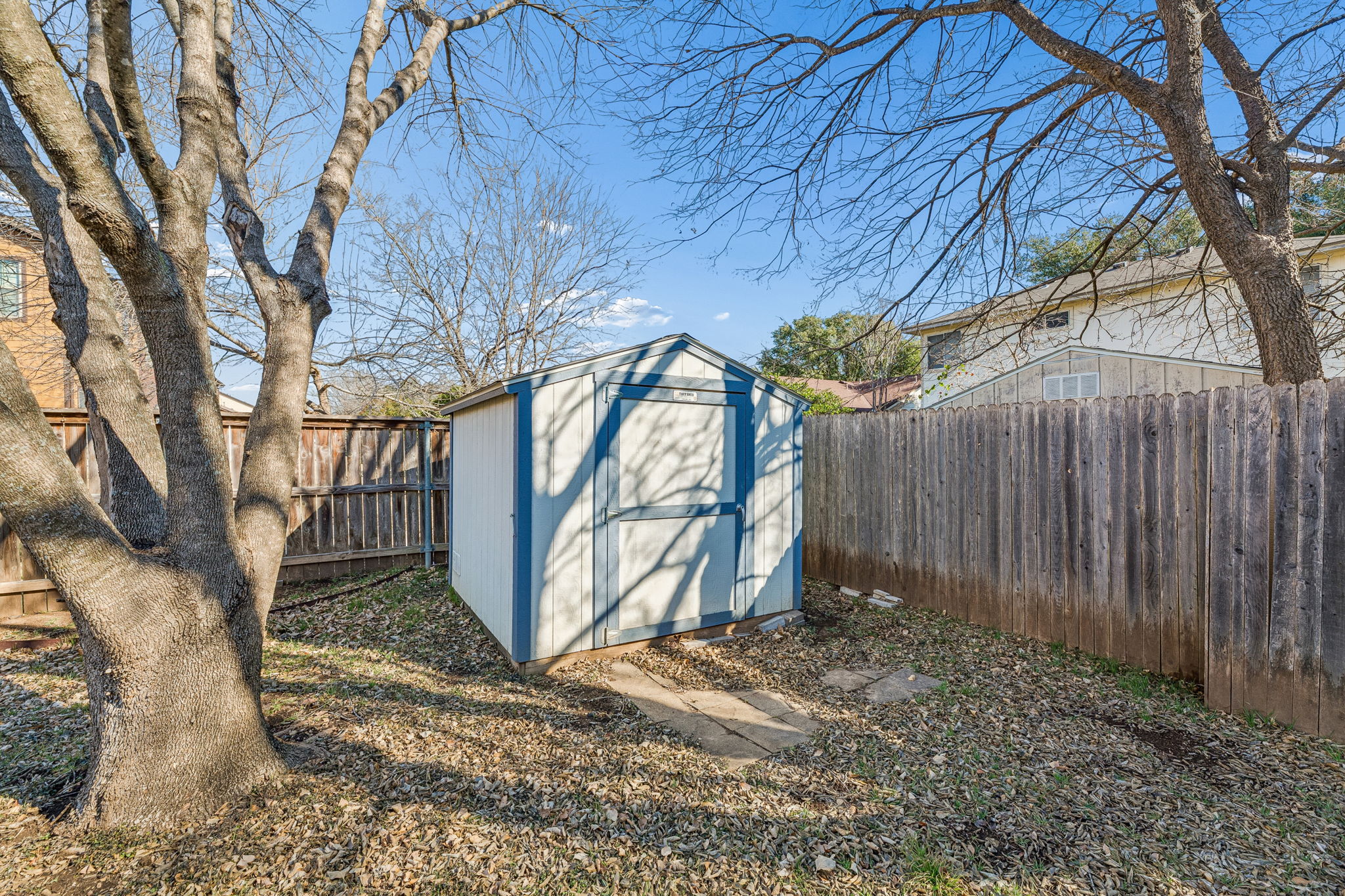 1608 Melibee Trail Austin, TX 78748 - Photo 27 of 29 a backyard of a house with large trees and wooden fence