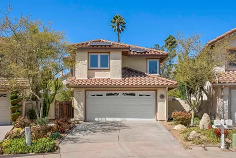 a front view of a house with a garage