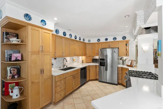 a kitchen with a refrigerator and a stove