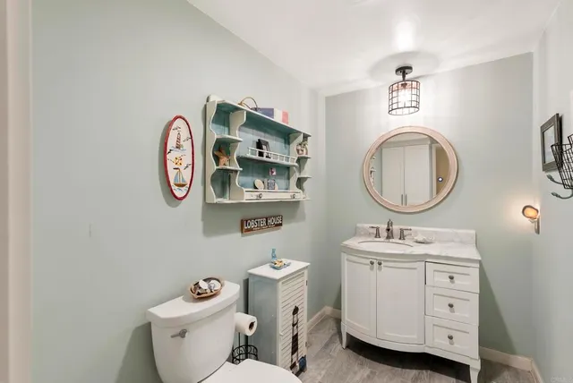 a bathroom with a toilet a sink and a mirror