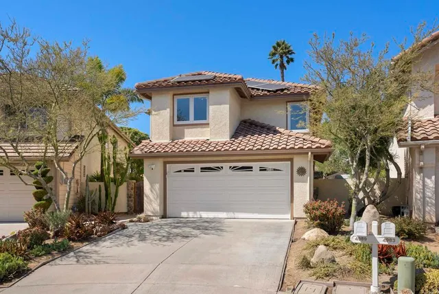 a front view of a house with a garage