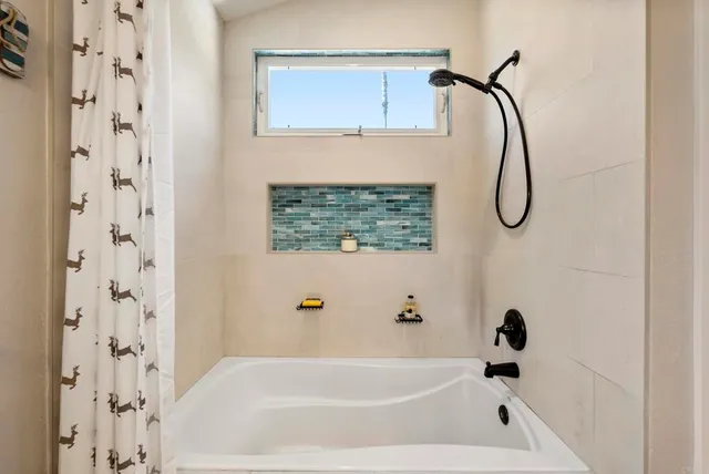 a bathroom with a bath tub
