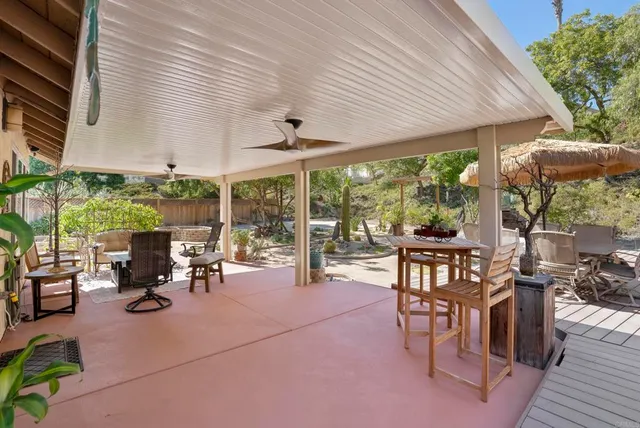 a view of a patio with table and chairs and potted plants