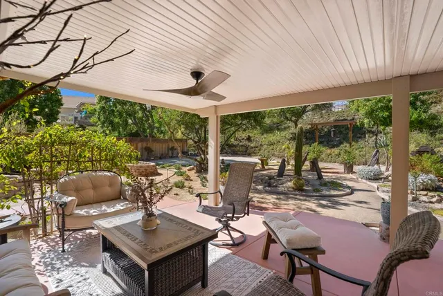 a view of a patio with table and chairs and potted plants