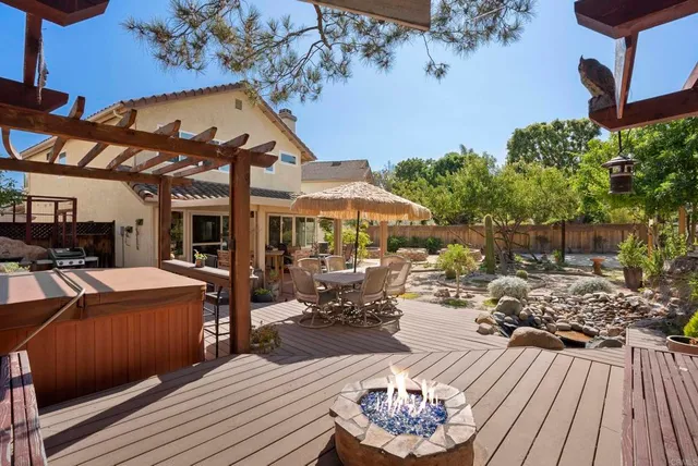 a view of a patio with table and chairs and potted plants
