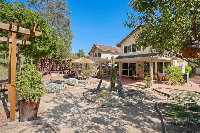 a view of a house with backyard and sitting area