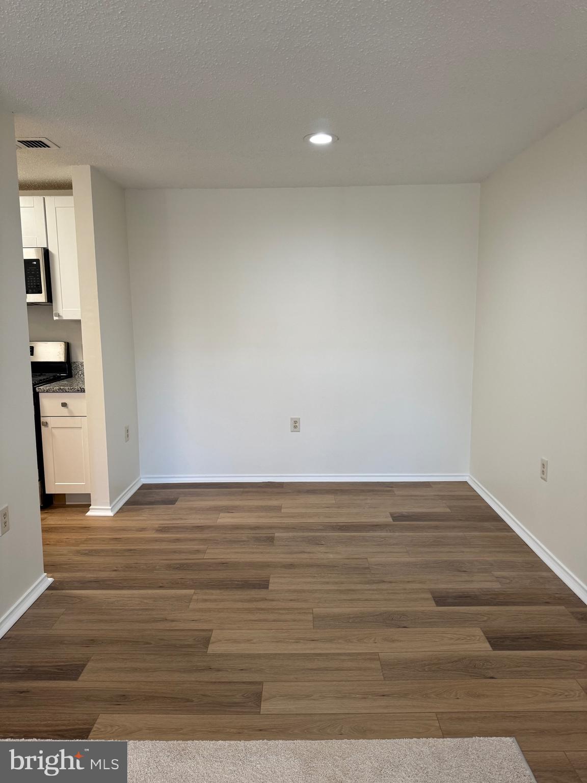 20952 Timber Ridge Terrace, Unit 301 Ashburn, VA 20147 - Photo 4 of 14 a view of an empty room and wooden floor
