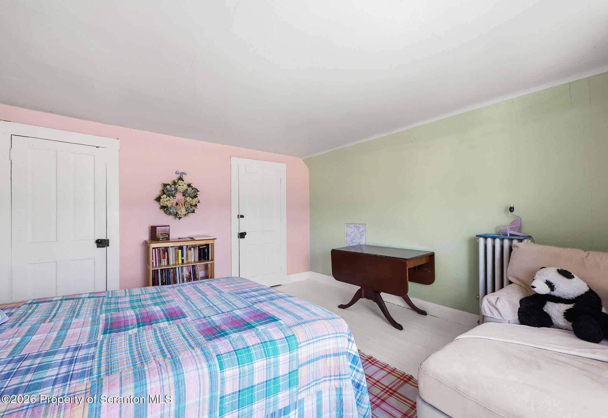 616 Myrtle Street Scranton, PA 18510 - Photo 42 of 65 a bedroom with a bed and a chandelier