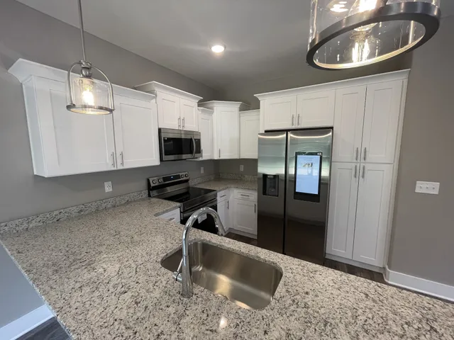 a kitchen with a stove a microwave and refrigerator