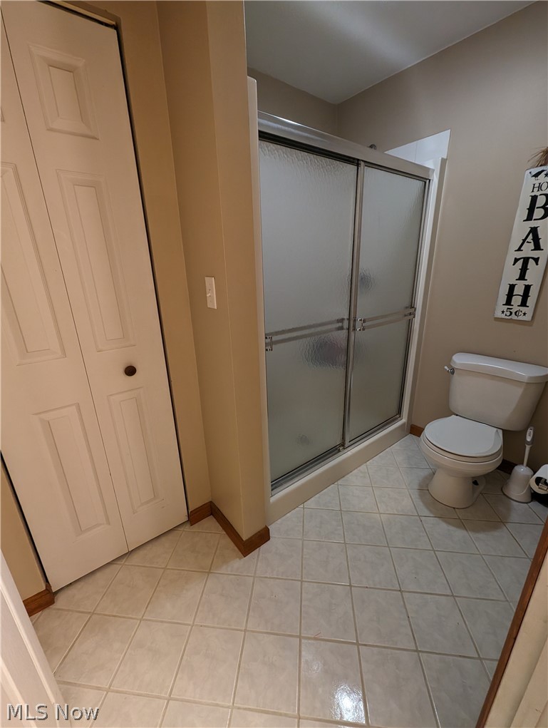 7272 Poore Road Conneaut, OH 44030 - Photo 20 of 26 Bathroom with a shower with door, toilet, and tile floors
