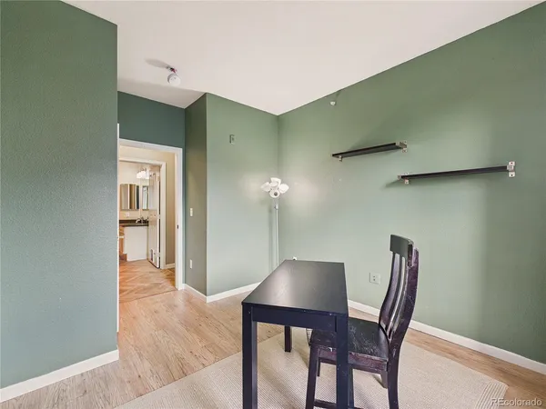 a bathroom with a granite countertop sink toilet and mirror