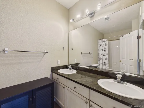 a white toilet sitting next to a bath tub shower