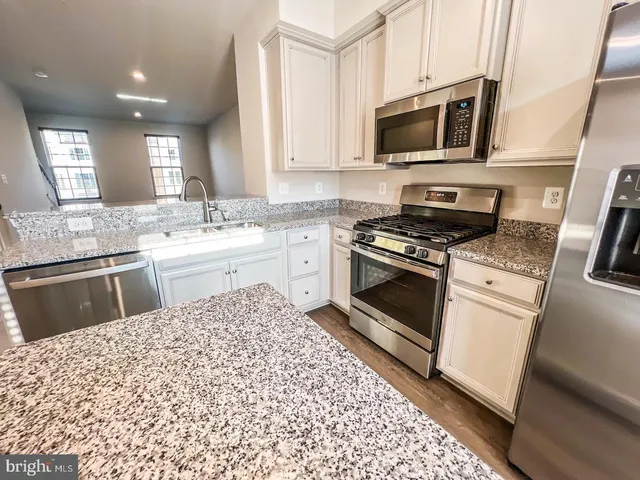 a kitchen with a stove a sink and a microwave