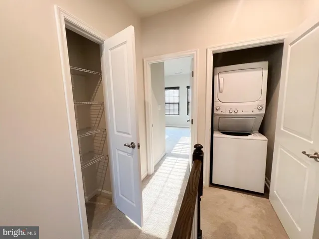 a view of a hallway with a white car parked in a room