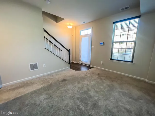 a view of an empty room with windows