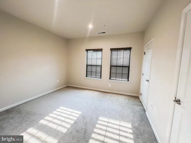 a view of an empty room with windows