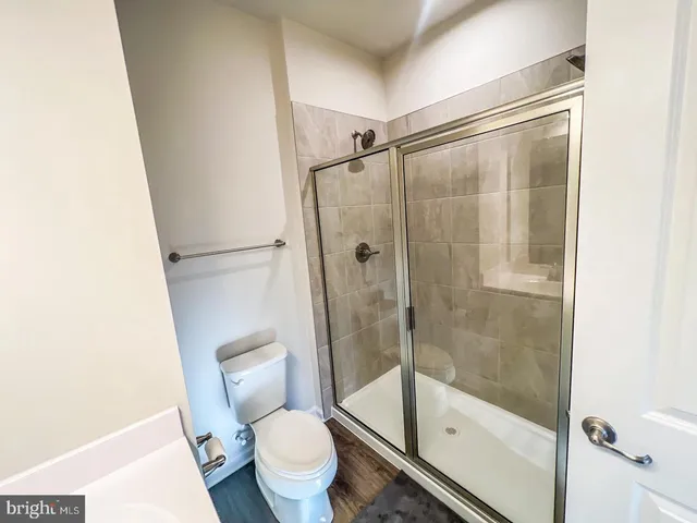 a bathroom with a shower a toilet and a shower