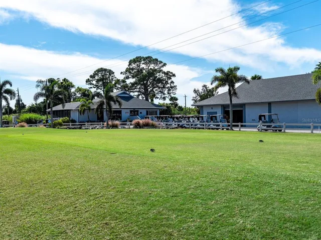 a view of a lake with a big yard and large trees
