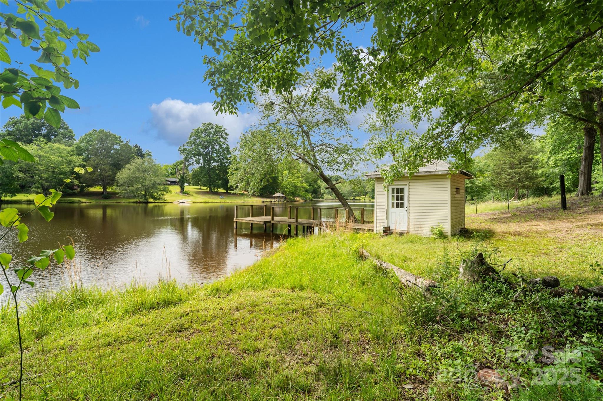 2021 Beamguard Road Clover, SC 29710 - Photo 20 of 33 a backyard of a house with lots of green space and lake view