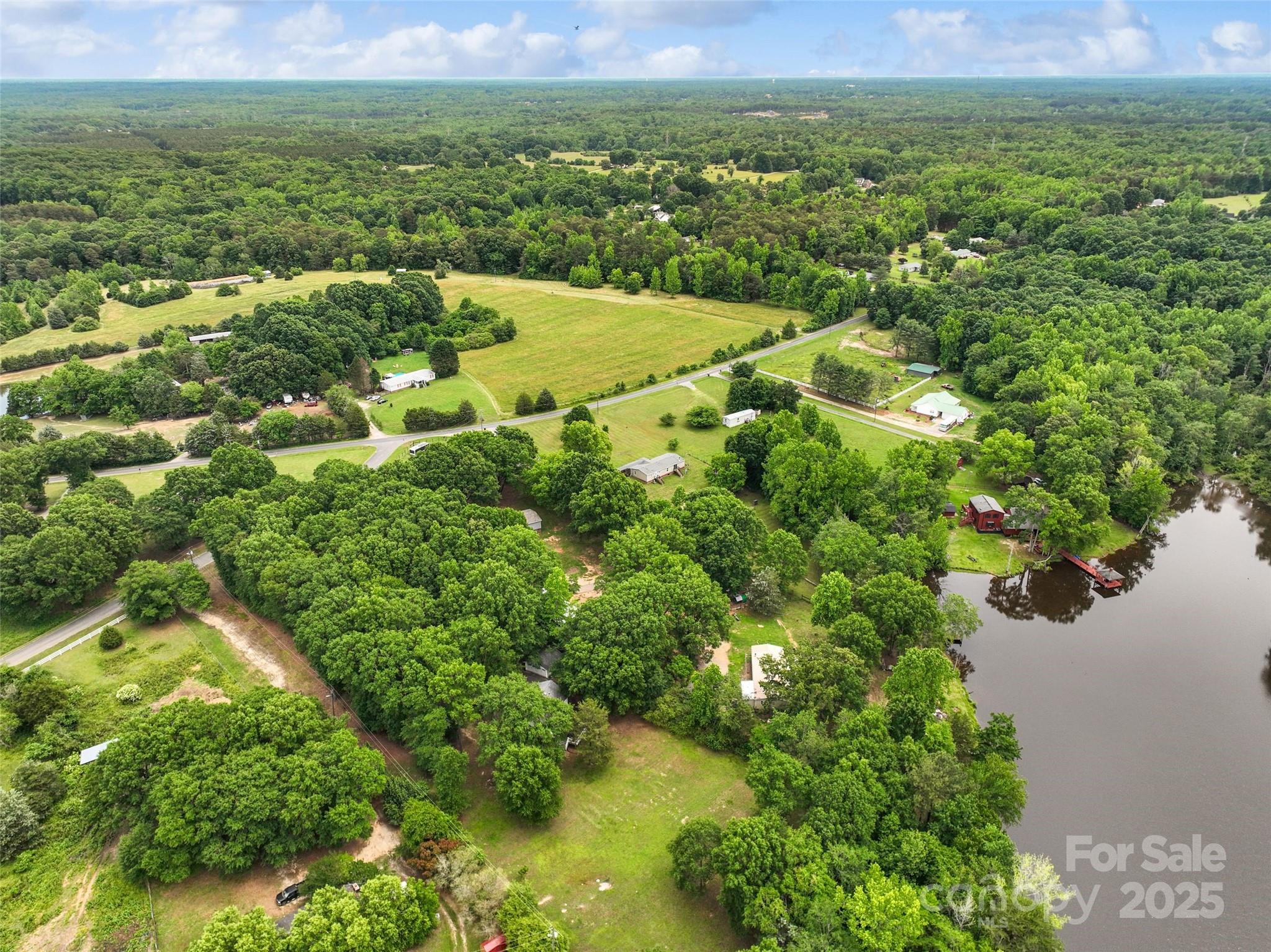 2021 Beamguard Road Clover, SC 29710 - Photo 26 of 33 a view of a lake with a building in the background