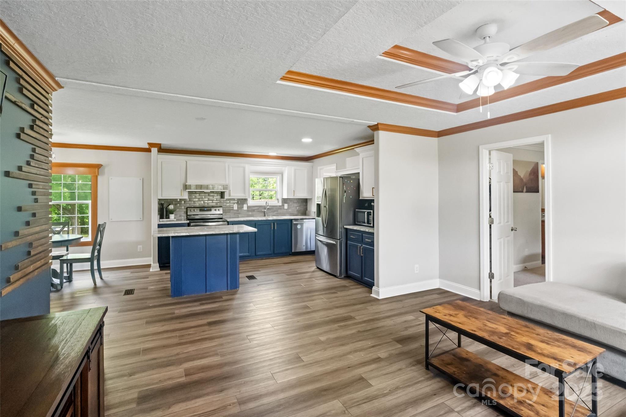 2021 Beamguard Road Clover, SC 29710 - Photo 3 of 33 a kitchen with stainless steel appliances kitchen island granite countertop a refrigerator a stove and a wooden floors