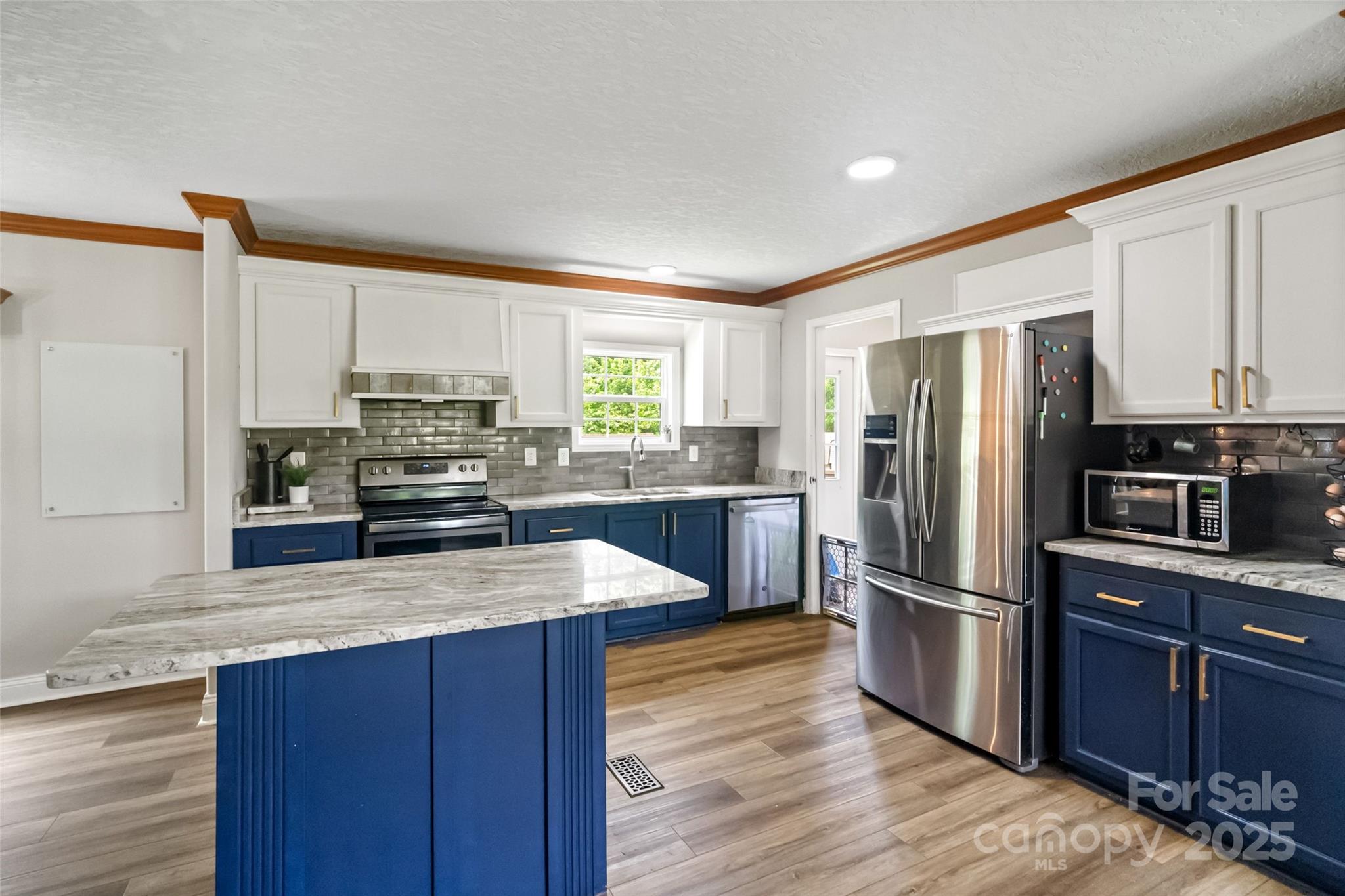 2021 Beamguard Road Clover, SC 29710 - Photo 7 of 33 a kitchen with wooden cabinets stainless steel appliances and window