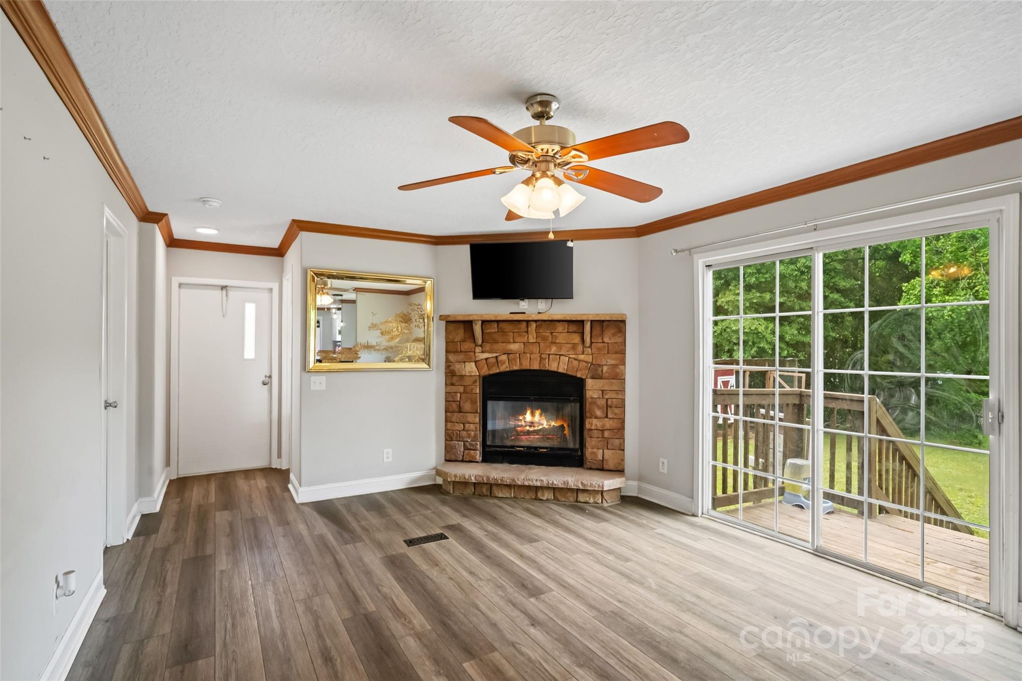 2021 Beamguard Road Clover, SC 29710 - Photo 9 of 33 a view of a livingroom with a fireplace and a ceiling fan