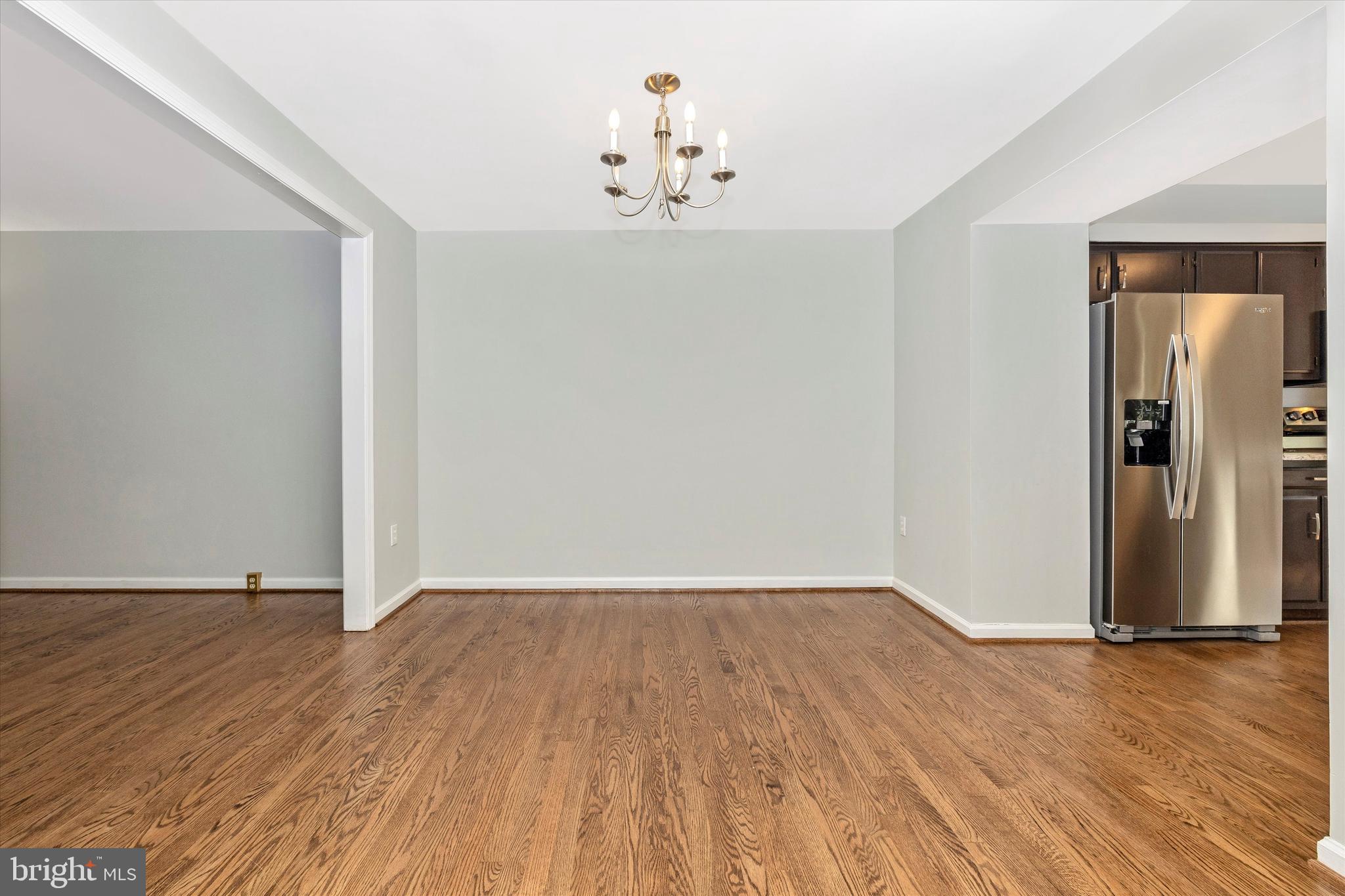 8001 Hollow Reed Court Frederick, MD 21701 - Photo 16 of 33 a view of an empty room with wooden floor and a window