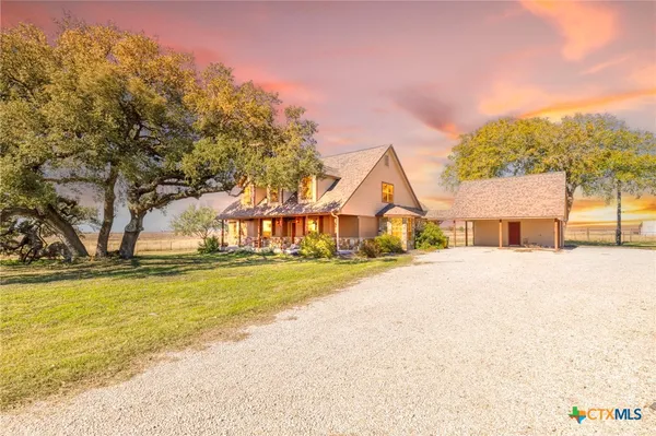 a view of a house with pool and a yard