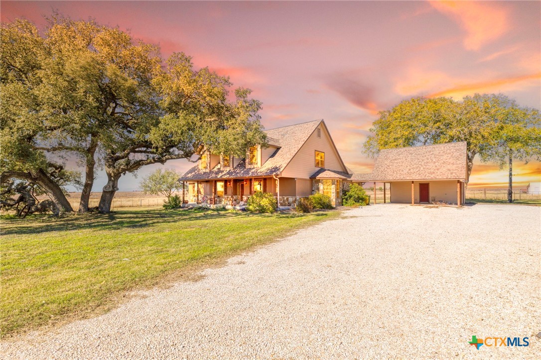 a view of a house with pool and a yard