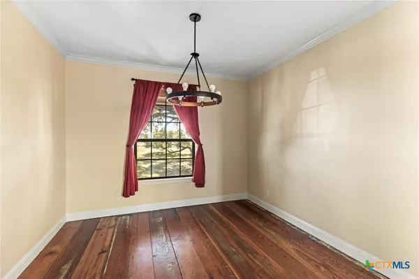 a large kitchen with kitchen island granite countertop a large window and stainless steel appliances