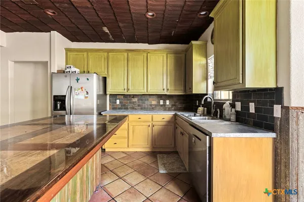 a spacious bathroom with a granite countertop sink a mirror and a bathtub