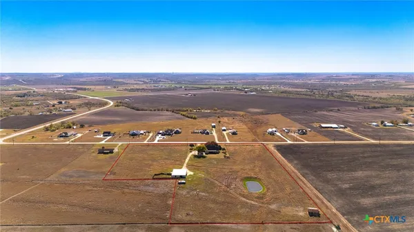 a view of a lake with houses in the back