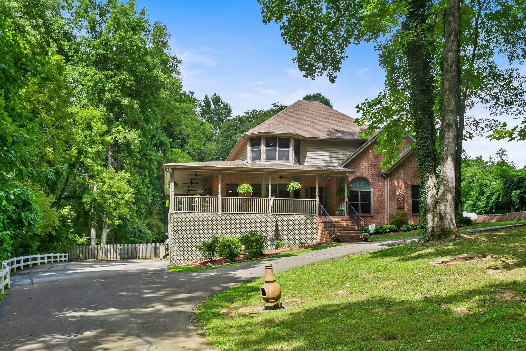830 Baker Road Columbia, TN 38401 - Photo 2 of 68 a front view of a house with a garden and trees