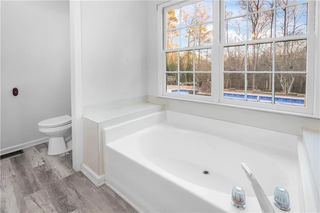 a bathroom with a bathtub and window