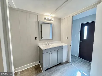 a view of a bathroom with mirror and sink