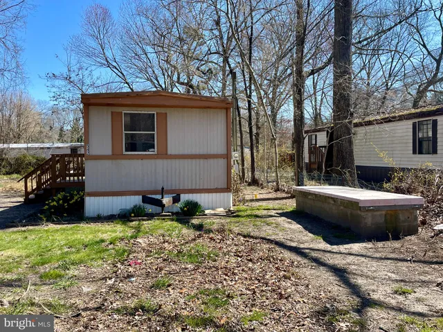 a view of house with backyard and seating area
