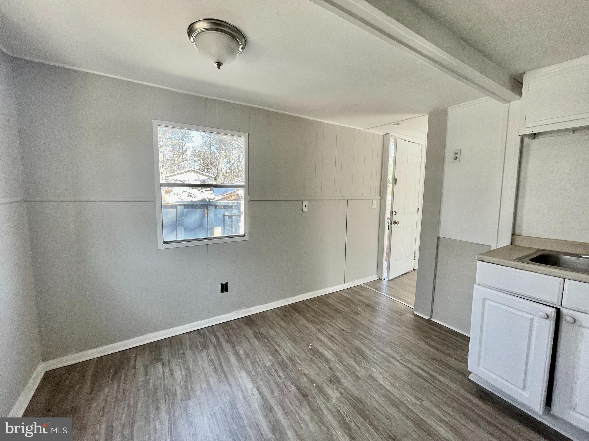 542 Gooseberry Road Millville, NJ 08332 - Photo 4 of 16 a view of a kitchen with wooden floor and a window