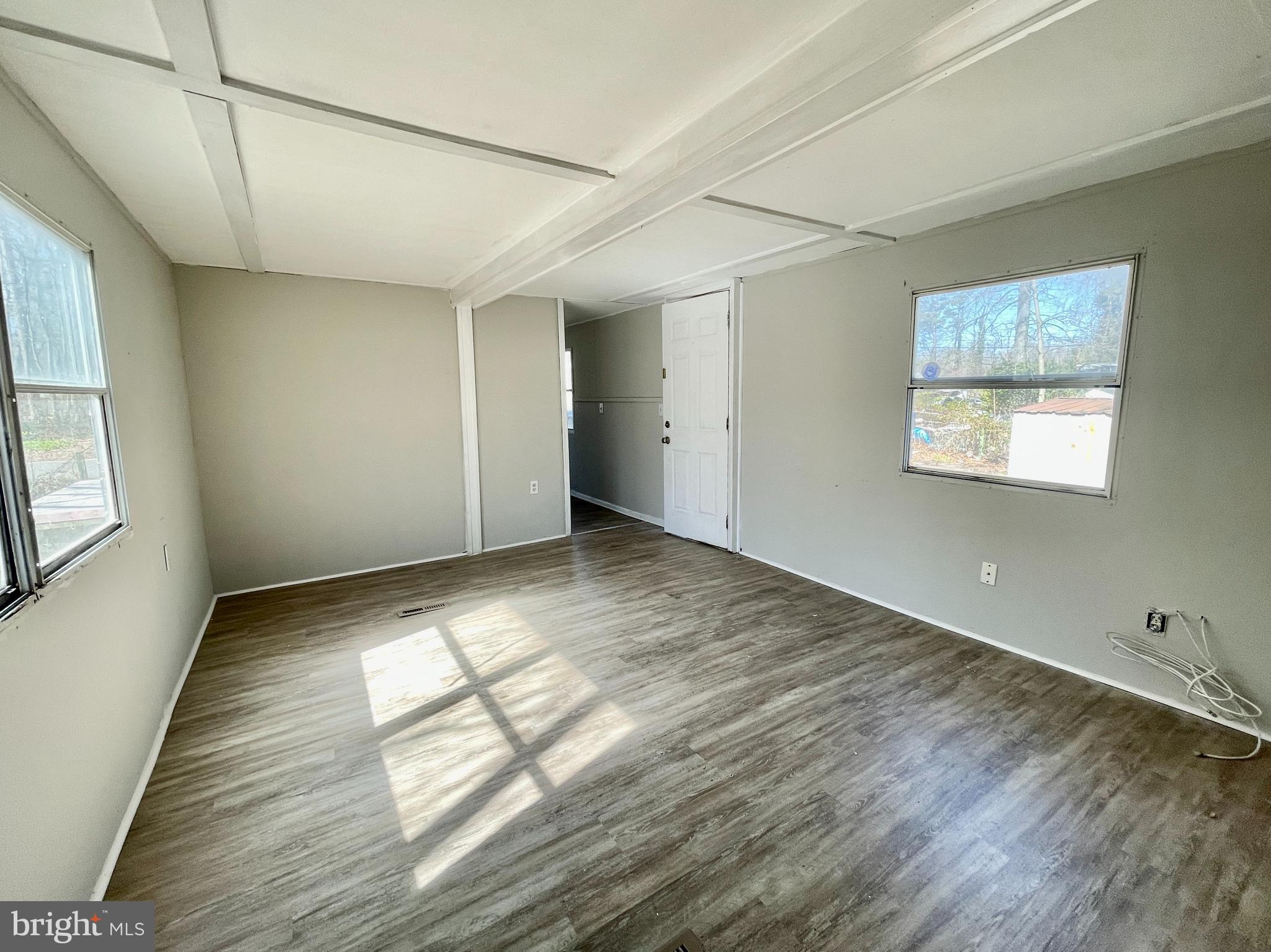 542 Gooseberry Road Millville, NJ 08332 - Photo 7 of 16 a view of empty room with wooden floor and fan