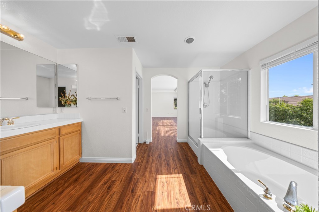 8679 Cabin Place Riverside, CA 92508 - Photo 22 of 35 a spacious bathroom with a tub shower and sink