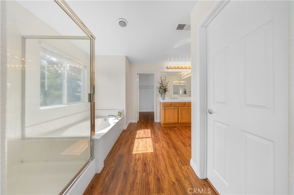 8679 Cabin Place Riverside, CA 92508 - Photo 25 of 35 a view of a hallway with wooden floor and staircase