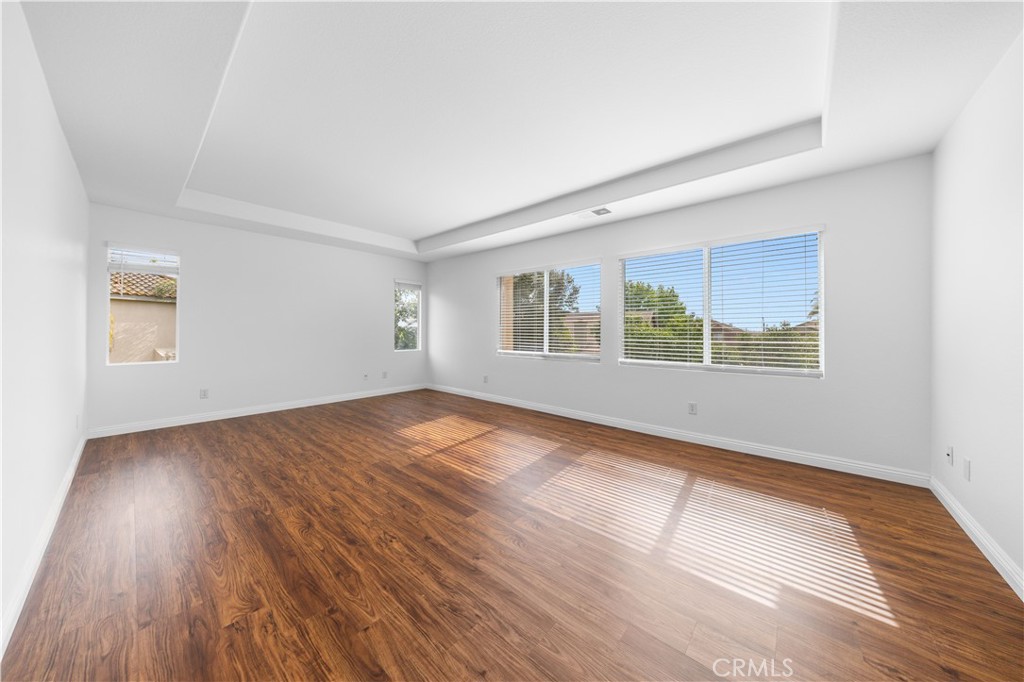 8679 Cabin Place Riverside, CA 92508 - Photo 26 of 35 a view of an empty room with wooden floor and a window