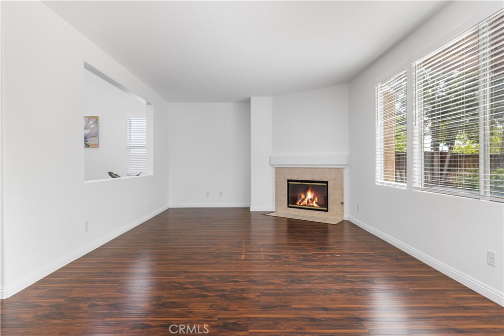 8679 Cabin Place Riverside, CA 92508 - Photo 6 of 35 a view of an empty room with wooden floor and a window