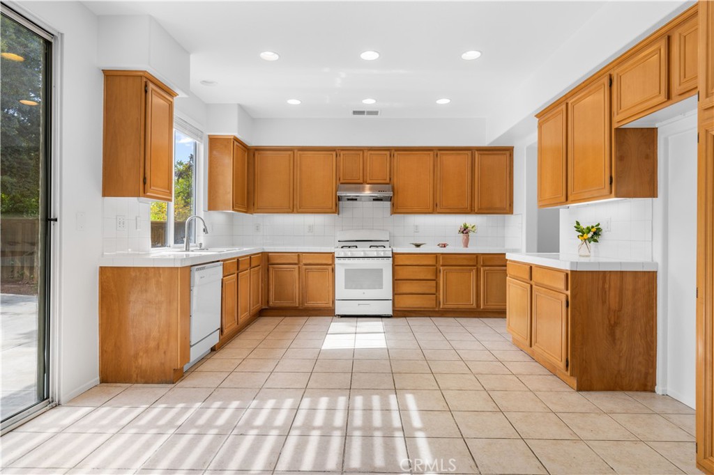 8679 Cabin Place Riverside, CA 92508 - Photo 7 of 35 a kitchen with a sink window and cabinets