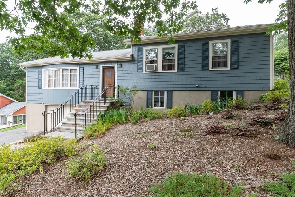 7 Grant Road Winchester, MA 01890 - Photo 1 of 39 a front view of a house with a garden